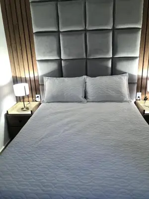a bedroom with a large bed with a large headboard at Encanto cerca al mar in Cartagena de Indias