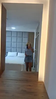 a woman taking a picture of a bed in a room at Encanto cerca al mar in Cartagena de Indias
