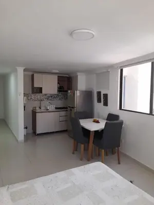 a kitchen and dining room with a table and chairs at Apartamento Amoblado in Cartagena de Indias