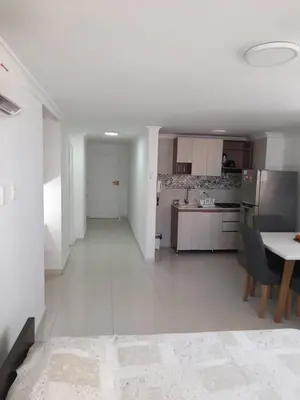 a large white kitchen with a table and chairs at Apartamento Amoblado in Cartagena de Indias