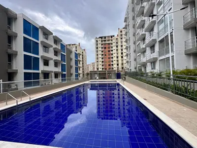 a swimming pool in the middle of some buildings at Apto con vista verde y aire acondicionado in Barranquilla