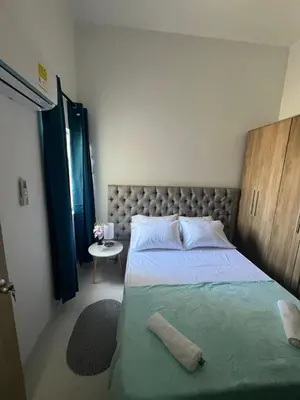 a bedroom with a large bed and a table at B lounge experience ctg bolívar in Cartagena de Indias