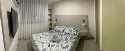 a cat sitting on a bed in a bedroom at Apartaestudio 91 in Barranquilla