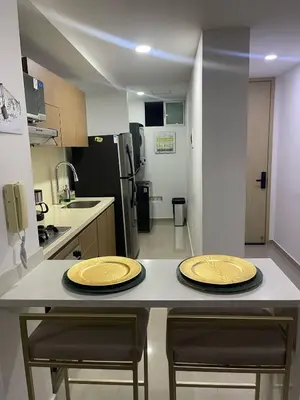 two yellow plates sitting on a counter in a kitchen at Apartaestudio 91 in Barranquilla