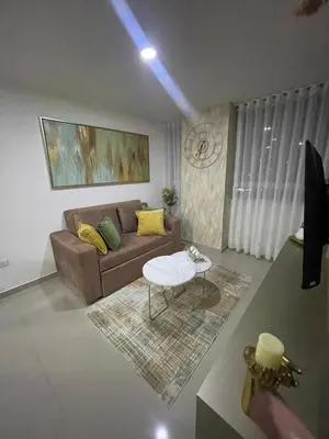 a living room with a couch and a table at Apartaestudio 91 in Barranquilla