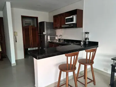 a kitchen with a counter and two bar stools at Ocean and Lagoon View Apartment in Cartagena El Laguito 804A in Cartagena de Indias
