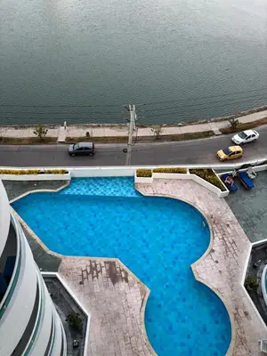 an overhead view of a swimming pool next to the water at Ocean and Lagoon View Apartment in Cartagena El Laguito 804A in Cartagena de Indias