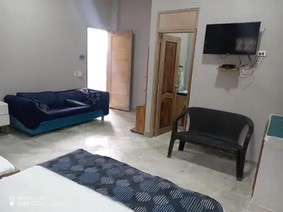 a living room with a blue couch and a chair at Terraza Del Sol in Coveñitas
