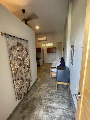 a hallway with a room with a bed and a wall at Terraza Del Sol in Coveñitas