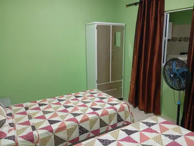 a bedroom with a bed with a quilt on it at Apartamentos el farol in Ciénaga