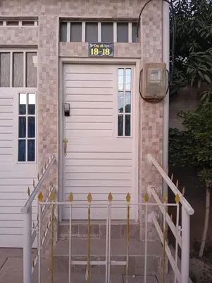a front door of a house with a clock on it at Apartamentos el farol in Ciénaga