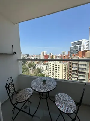 a balcony with a table and two chairs and a window at Luxury 14th floor with amazing view in Barranquilla