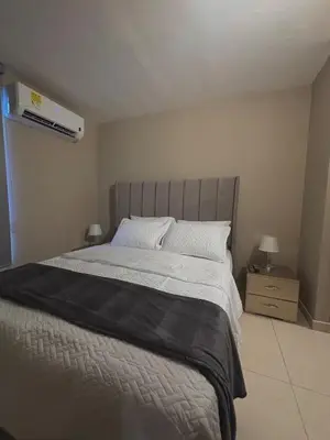 a bedroom with a large bed and a air conditioner at Apartment in Alameda del Río in Barranquilla