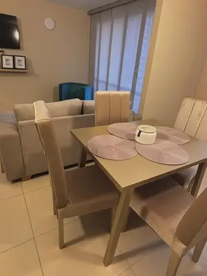 a living room with a table and a couch at Apartment in Alameda del Río in Barranquilla