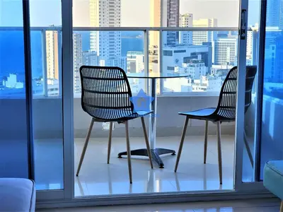 two chairs and a table in front of a window at Apartamento Vista Panorámica - Piso 20 in Cartagena de Indias