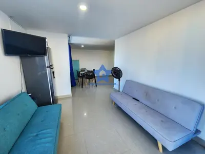 a living room with a blue couch and a table at Apartamento Vista Panorámica - Piso 20 in Cartagena de Indias