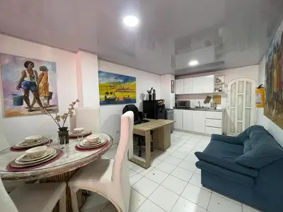 a living room with a table and a blue couch at Homethel Studio Apt privado in Cartagena de Indias