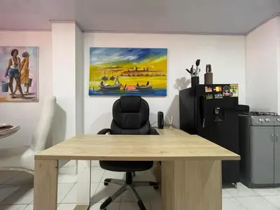 a kitchen with a wooden table and a black refrigerator at Homethel Studio Apt privado in Cartagena de Indias