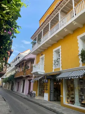 a yellow building with balconies on a street at Apartamento en Centro histórico de Cartagena in Estación El Salto