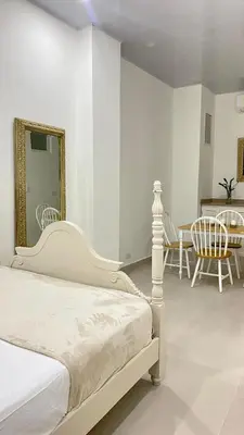 a bedroom with a bed and a table and chairs at Apartamento en Centro histórico de Cartagena in Estación El Salto