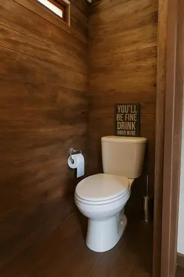 a bathroom with a toilet with a sign on the wall at Hacienda San Benito in Cartagena de Indias