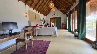 a bedroom with a bed and a tv in a room at Hacienda San Benito in Cartagena de Indias