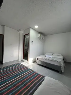 a bedroom with a bed and a rug on the floor at Casa Corales Cartagena in Cartagena de Indias