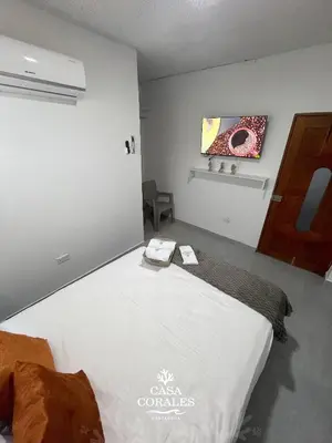 a bedroom with a large bed in a room at Casa Corales Cartagena in Cartagena de Indias