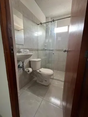 a bathroom with a toilet and a sink and a shower at Casa Corales Cartagena in Cartagena de Indias