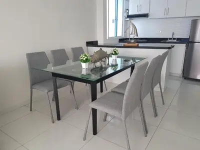 a dining room table with chairs and a glass top at Espectaculares Vistas, Edificio Nautilus, Barrio El Laguito. in Cartagena de Indias