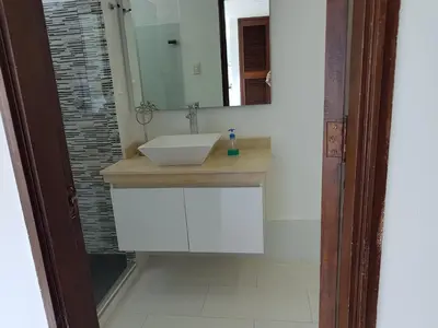 a bathroom with a white sink and a mirror at Espectaculares Vistas, Edificio Nautilus, Barrio El Laguito. in Cartagena de Indias