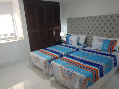 a bedroom with two beds and a large window at Espectaculares Vistas, Edificio Nautilus, Barrio El Laguito. in Cartagena de Indias