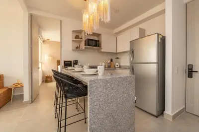 a kitchen with a counter and a refrigerator at Apartment with a Pool and Parking 2Bed in Cartagen in Cartagena de Indias
