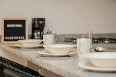 a counter with white bowls and plates on it at Apartment with a Pool and Parking 2Bed in Cartagen in Cartagena de Indias