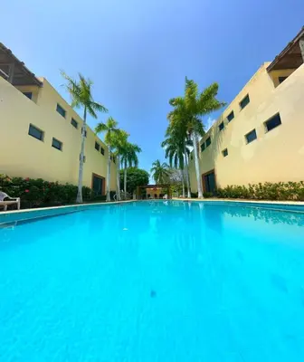a large swimming pool in front of two buildings at Exclusive Loft in Barú, access by sea and land in Isla Barú