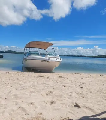 a boat sitting on the sand on a beach at Exclusive Loft in Barú, access by sea and land in Isla Barú