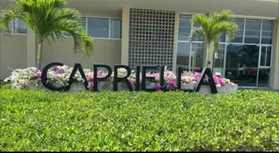 a sign that says gardens in front of a building at 