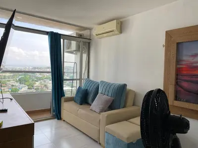 a living room with a couch and a large window at Amoblado cerca playa Marbella in Cartagena de Indias