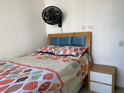 a bedroom with a bed and a fan at Amoblado cerca playa Marbella in Cartagena de Indias