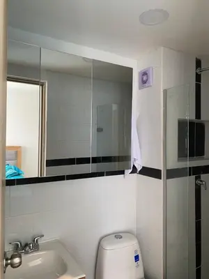 a bathroom with a toilet and a sink and a mirror at Amoblado cerca playa Marbella in Cartagena de Indias