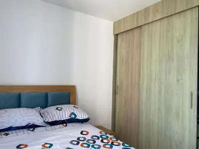 a bedroom with a bed and a wooden closet at Amoblado cerca playa Marbella in Cartagena de Indias