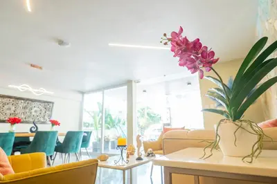 a living room with a vase of flowers on a table at Hotel Bahía Azul Manga Cartagena in Cartagena de Indias