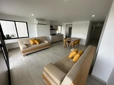 a living room with a couch and a table at Apartamento Moderno con Piscina en el Laguito in Cartagena de Indias