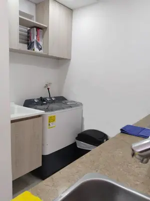 a small kitchen with a sink and a stove at EntreLagos Family Suite Vista a la Ciudad in Cartagena de Indias