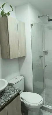 a bathroom with a toilet and a glass shower at EntreLagos Family Suite Vista a la Ciudad in Cartagena de Indias
