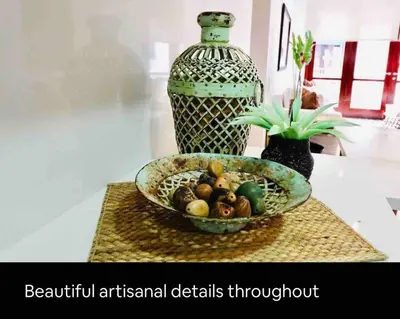 a bowl of fruit sitting on a table with a vase at Charming Cartagena Apartment Your Perfect Getaway in Cartagena de Indias