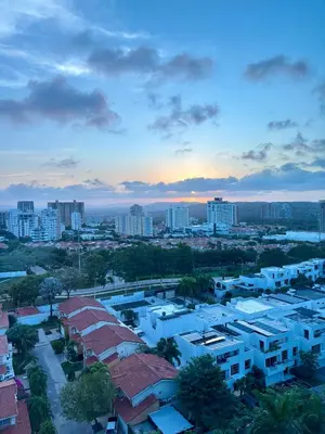 a view of a city at sunset with buildings at Apartamento entero amoblado con excelente ubicación en Barranquilla in Barranquilla