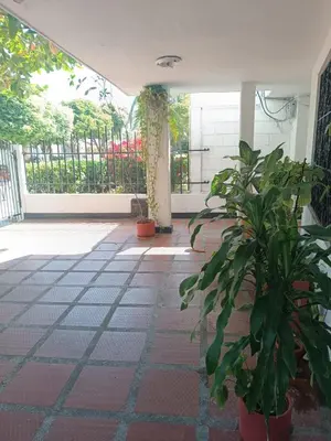 a hallway with plants in pots on a tile floor at Beach Airport House in Cartagena de Indias