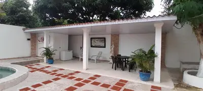 a patio of a house with a table and chairs at Villa Roy in Santa Marta