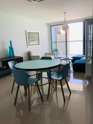a living room with a table and chairs and a couch at Luxurious and modern oceanfront apartment with views of the historic city 2B and 2BR in Cartagena de Indias